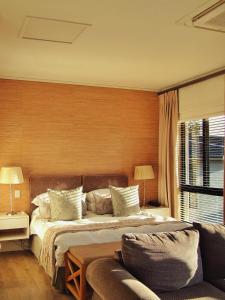 ein Schlafzimmer mit einem Bett und einem Sofa in der Unterkunft 210 Gallery Luxury Studio Apartment in Knysna