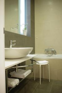 a bathroom with a white sink and a tub at Guest House Villa Dagmar in Crikvenica