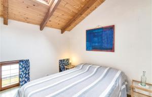 a white bedroom with a bed and a window at Casa Ila in Casasco
