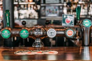 a bar with many different types of beer labels at Hotel Café Restaurant Abina in Amstelveen +6 photos