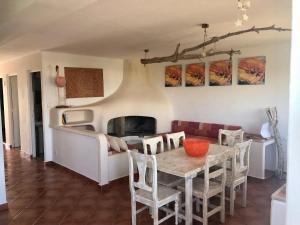 a dining room with a table and a fireplace at ED REXII ático 31 in Es Pujols