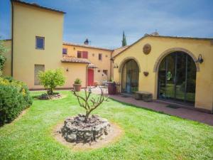 a garden with a tree in the middle of a yard at San Martin del Colle Holiday Home in Casciana Terme