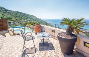 a patio with a table and chairs and the ocean at Gallinara in Borgio Verezzi