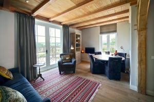 a living room with a blue couch and a table at Buitenplaats Welsdael in Margraten