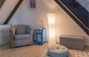 a living room with a chair and a lamp at Cozy Apartment In Friedrichskoog-Spitze in Friedrichskoog-Spitz