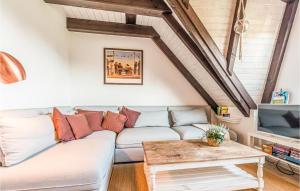 a living room with a couch and a table at Cozy Apartment In Friedrichskoog-Spitze in Friedrichskoog-Spitz