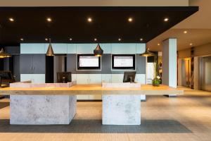 a lobby with a large table in the middle at ibis Hotel München Garching in Garching bei München