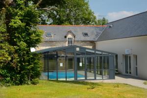 an extension to a house with a swimming pool at Terres de France Le Domaine de la Baie in Audierne