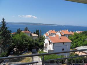 a view of a town with the water in the background at Apartments Petricevic in Selce