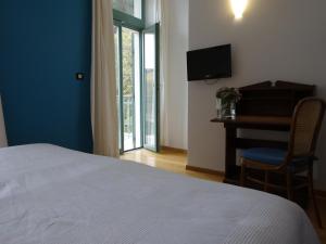 Un pat sau paturi într-o cameră la Hotel Televrin