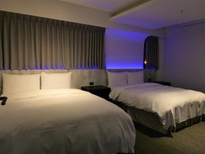 Postel nebo postele na pokoji v ubytování 泊居旅店二館 Oursinn Hotel 2