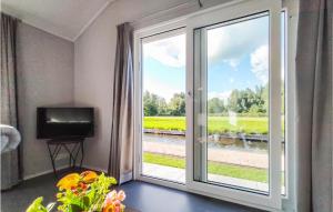 a room with a sliding glass door with a television at Waterpark Giethoorn 2 in Giethoorn