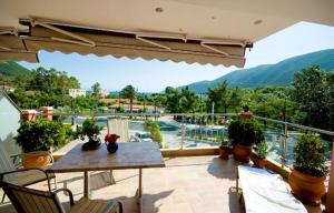 a patio with a table and chairs on a balcony at Imperial Studios in Vasiliki