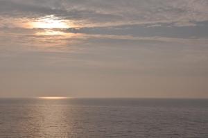 a view of the ocean with the sun in the sky at Fürstenhof Sassnitz in Sassnitz
