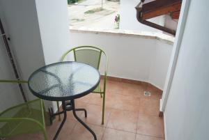 a table and chair in a room with a window at Hotel Laguna in Eforie Nord