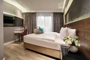a hotel room with a bed and a desk in it at Dora Pera Hotel in Istanbul
