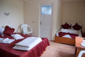 a bedroom with two beds with red and white towels at Hotel Laguna in Eforie Nord +30 photos