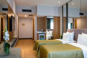 a hotel room with two beds and a television at Oran Hotel in Istanbul