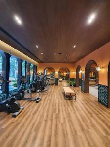 a gym with a bunch of treadmills and ellipticals at Lahabana Huahin by Moji in Hua Hin