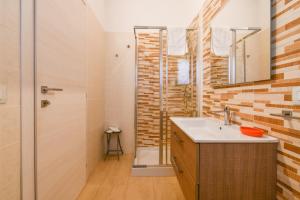 a bathroom with a sink and a shower at Calasole Country House in Torre Lapillo