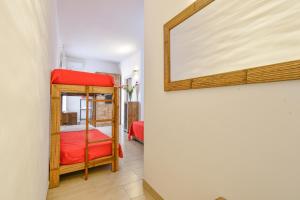 a room with a bunk bed and a mirror at Calasole Country House in Torre Lapillo