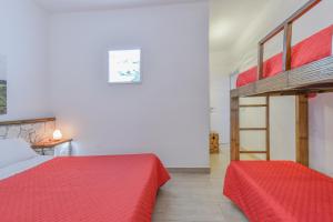 a bedroom with two beds and a loft bed at Calasole Country House in Torre Lapillo