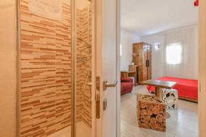 a sliding door in a room with a bedroom at Calasole Country House in Torre Lapillo