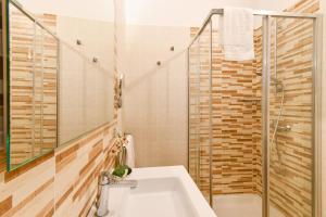 a bathroom with a sink and a shower at Calasole Country House in Torre Lapillo