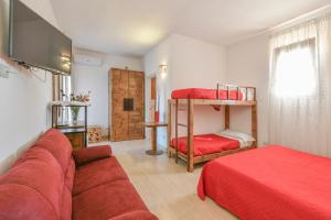 a living room with a couch and two bunk beds at Calasole Country House in Torre Lapillo