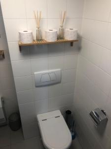 a bathroom with a toilet and three rolls of toilet paper at Seevilla Matilda direkt am Ufer in Jois