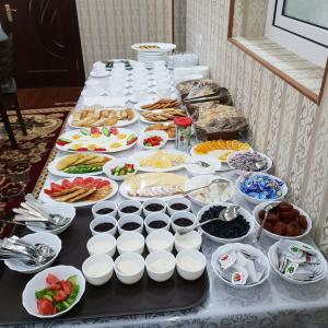a table with many different types of food on it at Muhtasham Hotel in Ichan Qala in Khiva +36 photos