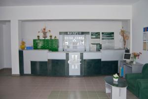 a lobby with a cash counter with a green couch at Hotel Cerna in Saturn