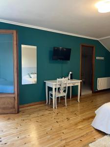 a room with a white table and a bed at Hotel Regueiro in Tox