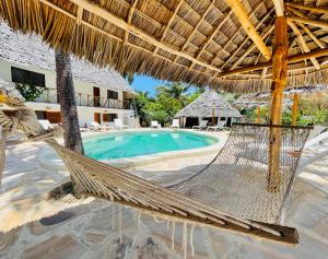 a resort with a hammock and a swimming pool at Oleza Boutique Hotel Zanzibar in Michamvi