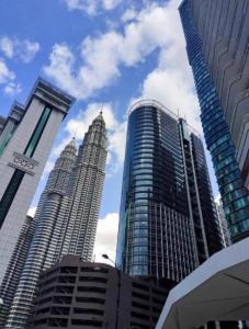 a group of tall buildings in a city at Cozy 2BR Suite 2 Min to KLCC and Saloma bridge in Kuala Lumpur
