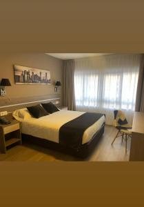 Un dormitorio con una cama grande y una ventana en Hotel El Haya, en Ontón