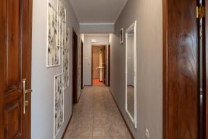 a hallway of a home with paintings on the walls at Apartment VEDA - Апартамент ВЕДА in Veliko Tŭrnovo