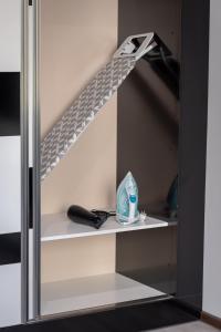 a shelf with a toothbrush and a bottle of toothpaste at Apartment Central-LUX 1 in Veliko Tŭrnovo