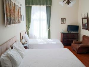 Ένα ή περισσότερα κρεβάτια σε δωμάτιο στο Alegre - Bussaco Boutique Hotel
