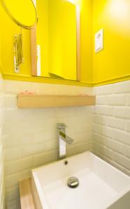 a bathroom with a white sink and a mirror at La Goélette, Chambres d'Hôtes in Wimereux +48 photos