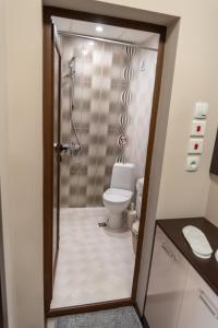 a bathroom with a shower and a toilet in it at Apartment Central-LUX in Veliko Tŭrnovo +3 photos