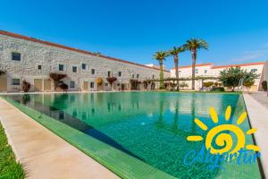 a swimming pool in front of a building at Convento das Bernardas By Algartur (AL) in Tavira