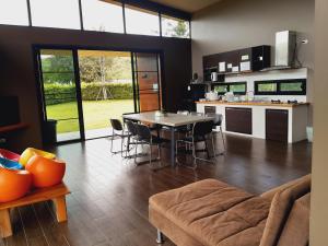 a kitchen and living room with a table and chairs at C-HILL@KHAOKHO in Khao Kho