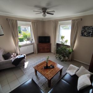 a living room with a couch and a coffee table at Ferienwohnungen zum Zilles in Treis-Karden