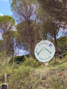 ein Schild an der Seite eines Hügels mit Bäumen in der Unterkunft Il Cantico delle Cicale in Piccione