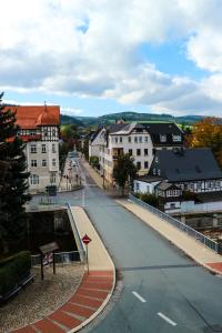 an empty street in a town with buildings at Pension Zur Wartburg in Olbernhau