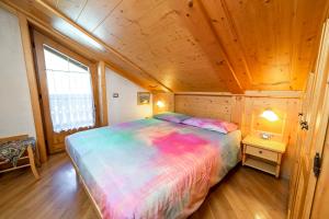 Un pat sau paturi într-o cameră la Chalet La Nuvola