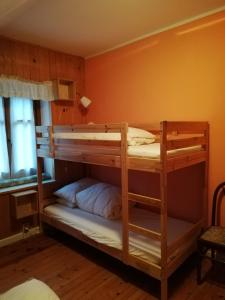 a bunk bed room with two bunk beds in it at Ostello SanMartino in San Martino di Castrozza