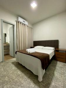 A bed or beds in a room at Suítes Bem Querer