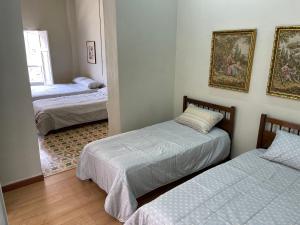 a bedroom with two beds and a mirror at Del Rocío Alojamiento -ANDES in Los Andes